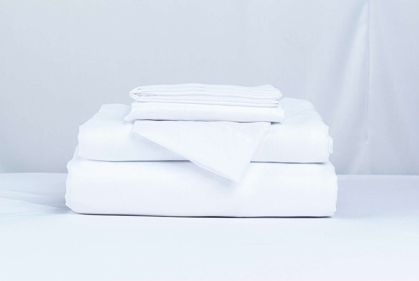 Neatly folded crisp white hotel linen