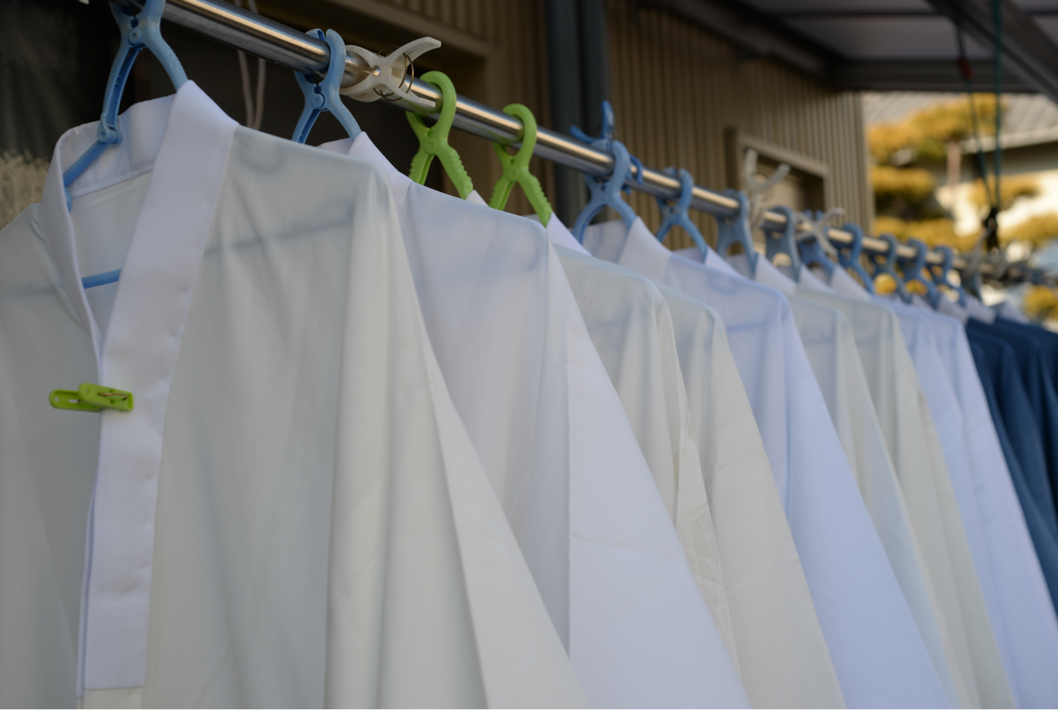 Freshly laundered white uniforms and workwear hanging to dry